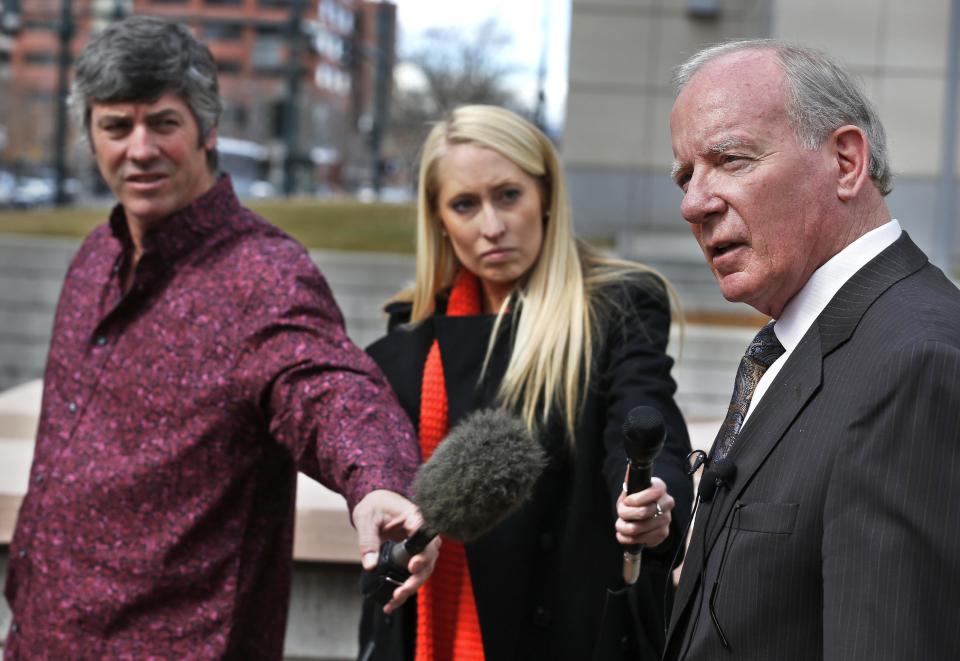 Daniel T. Smith, right, the attorney for Stevie Marie Anne Vigil, speaks with members of the media following a sentencing hearing for Vigil, who pleaded guilty to buying the handgun used to kill Nathan Leon and the director of Colorado Prisons, at the Federal Courthouse, in Denver, Monday March 3, 2014. Vigil was sentenced to more than two years in prison and three years supervision for buying the handgun for Evan Ebel, a parolee and member of a white supremacist prison gang. (AP Photo/Brennan Linsley)