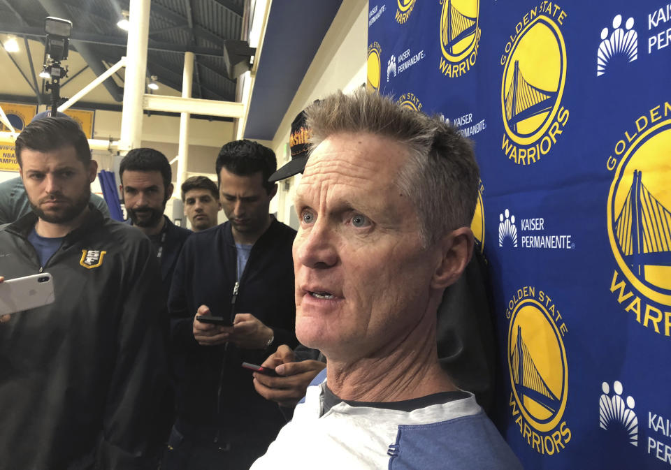 Golden State Warriors coach Steve Kerr talks with reporters at the NBA basketball team's practice facility Friday, June 14, 2019, in Oakland, Calif. Their three-peat quest denied by the champion Raptors, the Warriors now brace for major uncertainty ahead as Kevin Durant begins a long rehab from right Achilles tendon surgery and must decide where to sign and Klay Thompson has a torn left ACL that will be another lengthy recovery. (AP Photo/Janie McCauley)