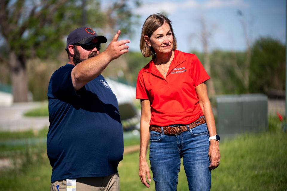 Gov. Kim Reynolds speaks with Adair and Guthrie County Emergency Manager Jeremy Cooper as they tour the remaining damage from the Greenfield tornado Tuesday, June 11, 2024.