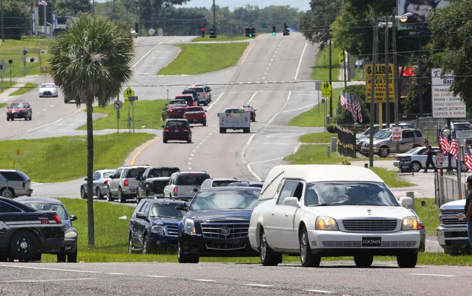 <p>The funeral procession of Miguel Angel Honorato heads up South Orange Blossom Trail after departing St. Francis of Assisi Catholic Church, in Apopka, Fla., north of Orlando, Tuesday, June 21, 2016. (Joe Burbank/Orlando Sentinel via AP) </p>