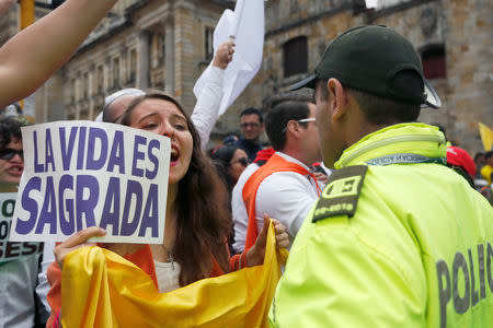 People take part in a rally against violence, following a car bomb explosion, in Bogota, Colombia January 20, 2019. The placard reads, "Life is sacred". REUTERS/Luisa Gonzalez