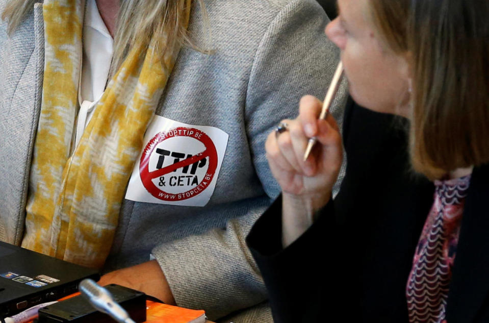 A deputy wears a sticker against TTIP and CETA during a debate in Namur