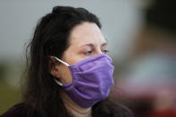 Rachel Adamus' eyes fill with a tear as she watches her children Paul and Neva head to the first day of school during the coronavirus outbreak on Monday, Aug. 3, 2020, in Dallas, Ga. With a new school year beginning this week in some states, Adamus is struggling to balance her fears with her belief that her children need to go to school for the sake of their education. (AP Photo/Brynn Anderson)