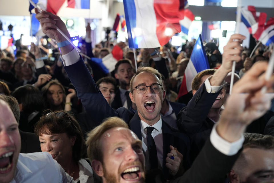 Supporters of French far-right National Rally react at the party election night headquarters, Sunday, June 9, 2024 in Paris. First projected results from France put far-right National Rally party well ahead in EU elections, according to French opinion poll institutes. (AP Photo/Lewis Joly)