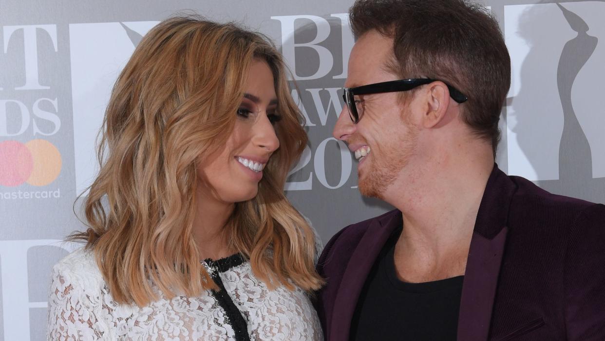 Stacey Solomon in a white lace top with Joe Swash in a suit