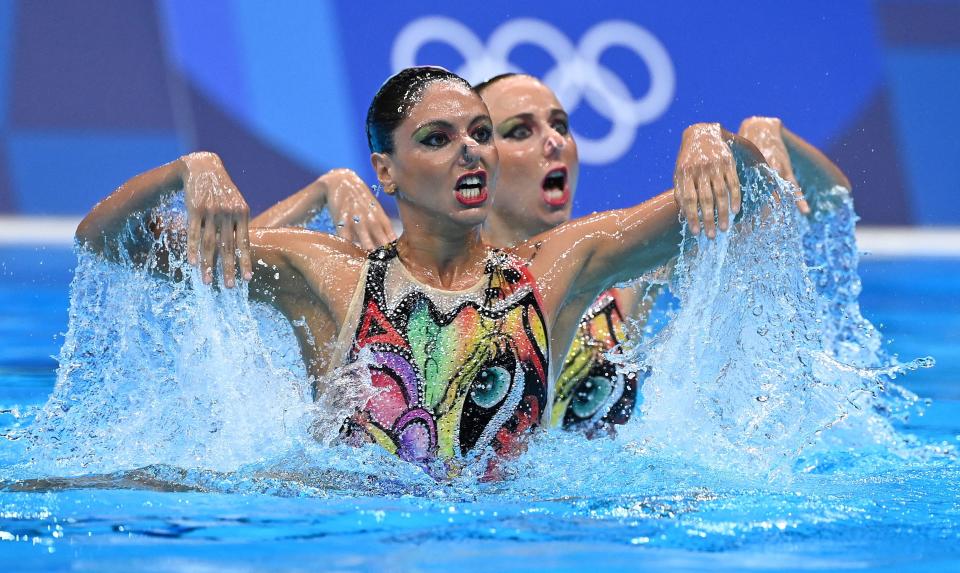 <p>Italy's Linda Cerruti and Italy's Costanza Ferro compete in the preliminary for the women's duet free artistic swimming event during the Tokyo 2020 Olympic Games at the Tokyo Aquatics Centre in Tokyo on August 2, 2021. (Photo by Attila KISBENEDEK / AFP) (Photo by ATTILA KISBENEDEK/AFP via Getty Images)</p> 