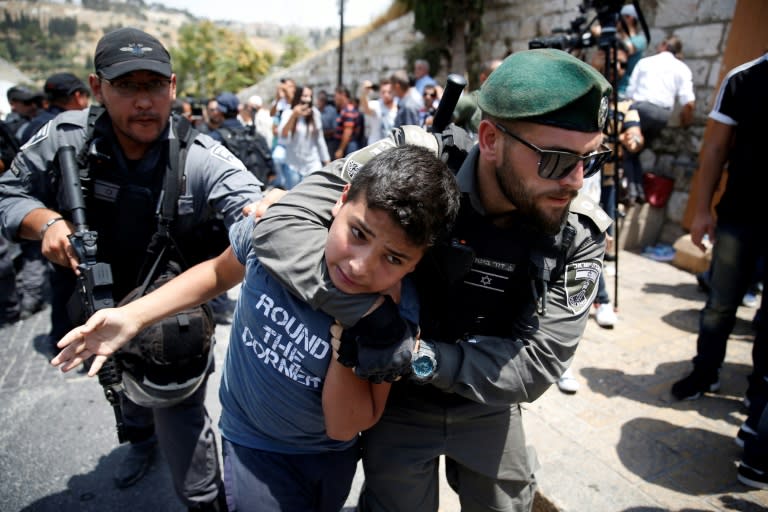 Israeli border guards detain a Palestinian youth outside the Lions Gate entrance to the Al-Aqsa mosque compound in Jerusalem's Old City on July 17, 2017