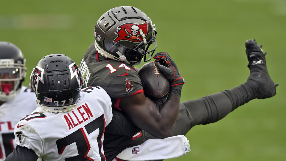 Tampa Bay Buccaneers wide receiver Chris Godwin (14) makes a catch in front of Atlanta Falcons free safety Ricardo Allen (37) during the second half of an NFL football game Sunday, Jan. 3, 2021, in Tampa, Fla. (AP Photo/Jason Behnken)