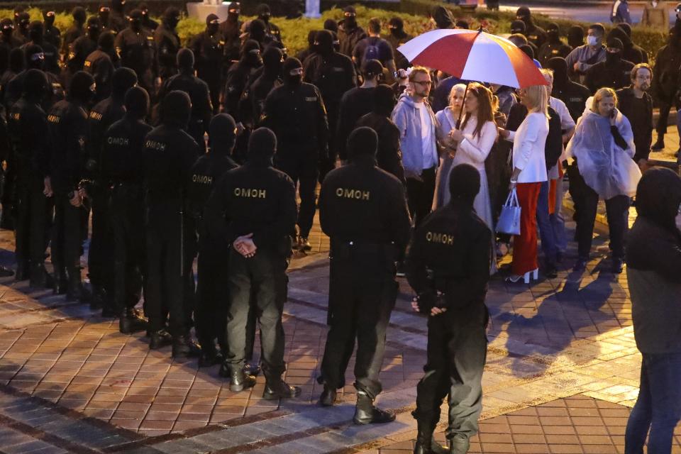 Police surrounded protesters during a Belarusian opposition supporters rally at Independence Square in Minsk, Belarus, Wednesday, Aug. 26, 2020. Protests demanding the resignation of Belarus' authoritarian President Alexander Lukashenko have entered their 18th straight day on Wednesday. (AP Photo/Sergei Grits)