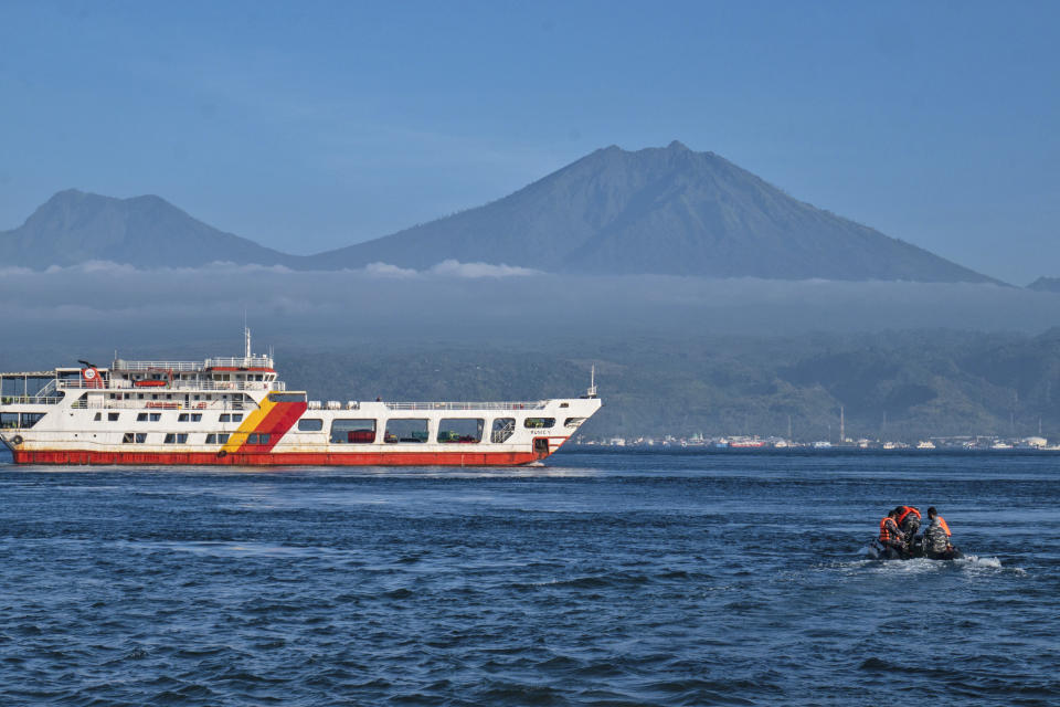 Indonesian Navy personnel sail on a rubber boat during a rescue operation for victims of the sinking ferry KMP Yunice near Gilimanuk Port on Bali Island, Indonesia, Wednesday, June 30, 2021. Rescuers on Wednesday were searching for people missing in rough seas overnight. (AP Photo/Fauzy Chaniago)