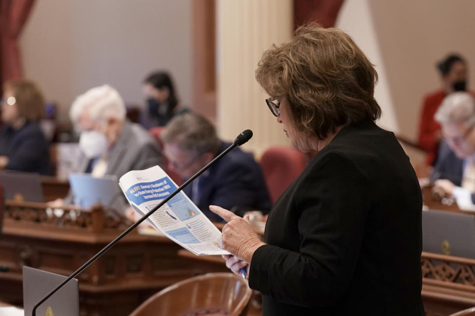 Republican state Sen. Shannon Grove, whose Bakersfield district is one of the state's oil hubs, reads from a flier outlining how a proposal to ban neighborhood oil drilling would hurt her district, during the Senate session at the Capitol in Sacramento, Calif., Wednesday, Aug. 31, 2022. The legislation passed and now goes to Gov. Gavin Newsom, who is expected to sign it. (AP Photo/Rich Pedroncelli)