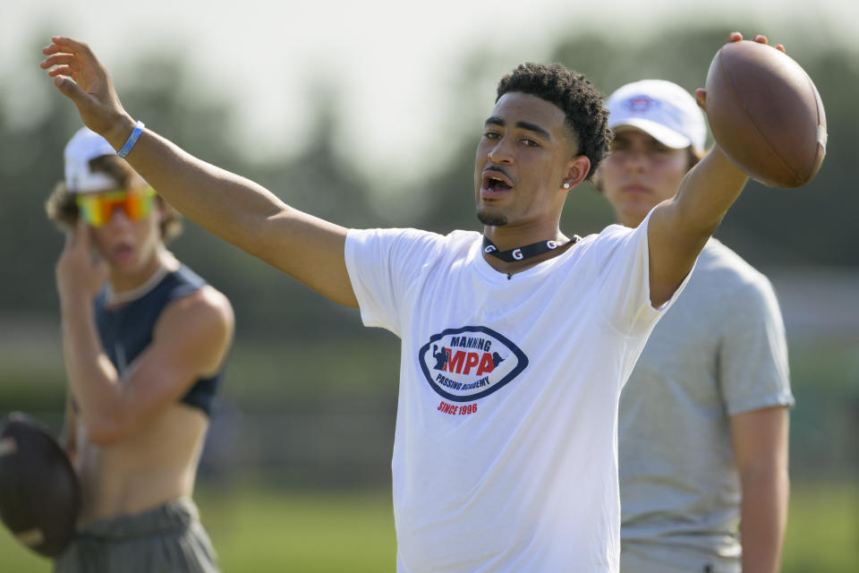 FILE - Alabama quarterback Bryce Young runs a drill at the Manning Passing Academy on the Nicholls State University campus in Thibodaux, La. Friday, June 24, 2022. More than a year ago, the NCAA lifted long-standing restrictions on players profiting from themselves, and in some cases it turned elite players such as Stroud and Alabama quarterback Bryce Young into instant millionaires. But the financial benefits for some athletes are being weighed against the possibility that such deals will divide locker rooms, create tension within programs, produce an uneven playing field across college athletics and overwhelm students stretched for time. (AP Photo/Matthew Hinton, File)