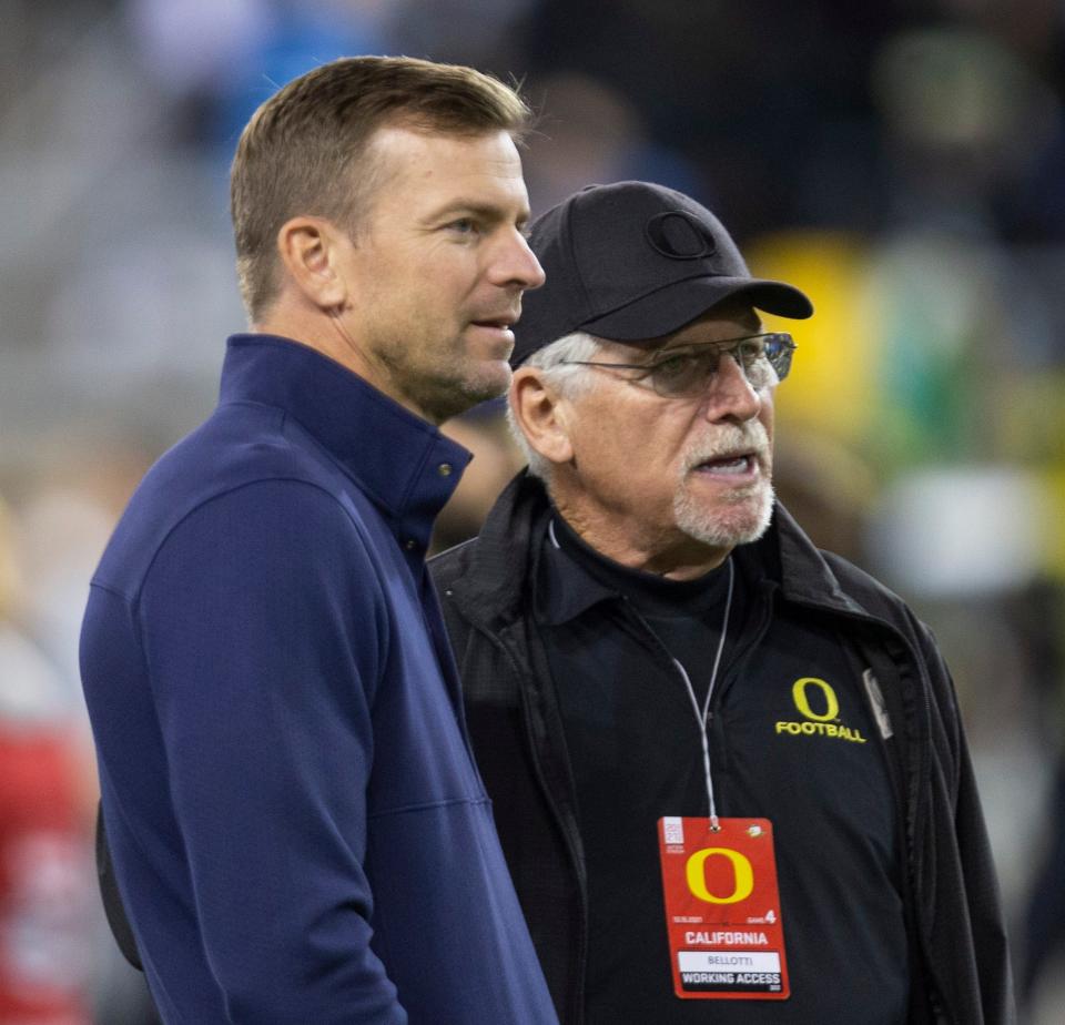 California coach Justin Wilcox, left, talks with former Oregon coach Mike Bellotti before the game against the Ducks at Autzen Stadium in 2021.
