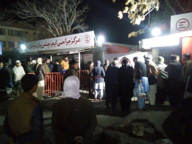 Relatives of blast victims gather outside a hospital of Italian NGO Emergency in Kabul following a suicide attack at a meeting of top clerics in the Afghan capital