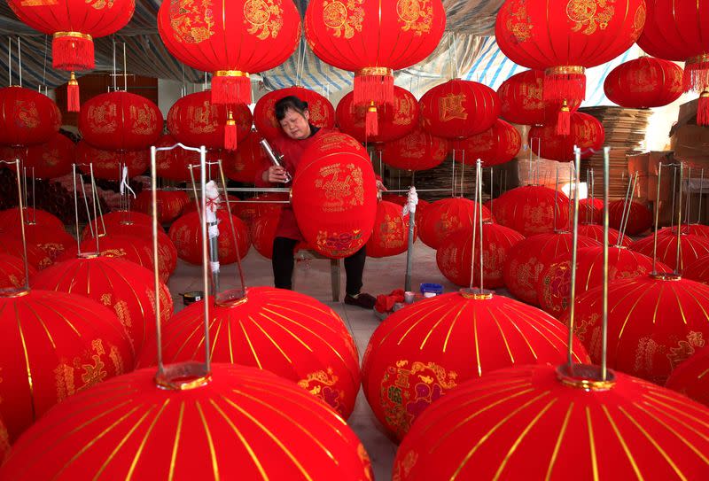 A villager makes red lanterns at a workshop in Anqing, Anhui