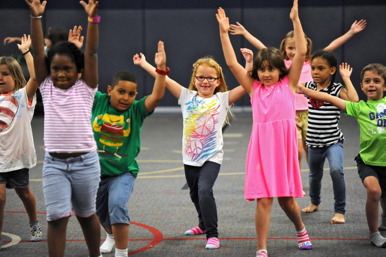 In this 2014 file photo, Alimacani Elementary School first-graders participate in a Yoga 4 Change session. The nonprofit uses yoga to promote healthy living and will be among the fitness event hosts for the upcoming free Riverfront Family Fitness & Fun series for the Jacksonville community.