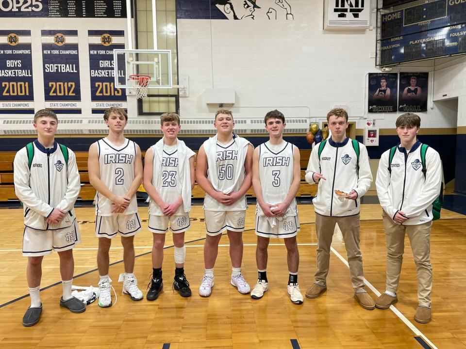 Batavia Notre Dame's Chase Aminore, Ryan Fitzpatrick, Jaden Sherwood, Mavrik Hall, Jay Antinore, George Woodruff and Evan Fitzpatrick after a senior night 66-49 victory over visiting Elba on Tuesday, Feb. 6. The Fighting Irish improved to 13-4.