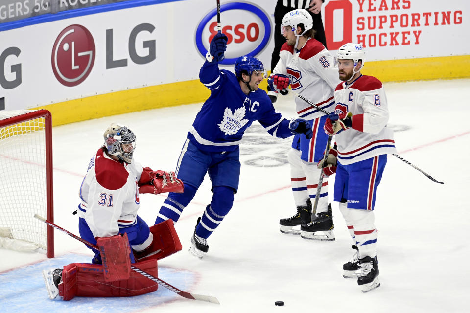 Toronto Maple Leafs' John Tavares (91) celebrates after scoring on Montreal Canadiens goaltender Carey Price (31) during the first period of an NHL hockey game in Toronto, Wednesday, Jan. 13, 2021. (Frank Gunn/The Canadian Press via AP)