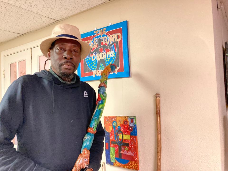 Joe Rob, 55, is among the guests staying at a winter shelter in West Asheville. He stands with some of his artwork.