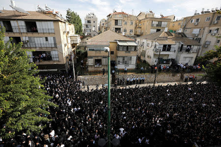 Ultra-Orthodox Jews gather outside the house (C) of prominent spiritual leader Rabbi Aharon Yehuda Leib Shteinman, who died on Tuesday at the age of 104, as they wait for this funeral to begin in Bnei Brak near Tel Aviv, Israel December 12, 2017. REUTERS/Amir Cohen