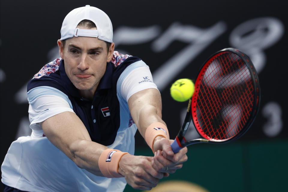 FILE - John Isner, of the United States, hits a backhand return to Adrian Mannarino, of France, at the Australian Open tennis tournament in Melbourne, Australia, Jan. 18, 2023. Isner will retire from professional tennis after playing at the U.S. Open, he announced Wednesday, Aug. 23, 2023, bringing an end to a career that included one Grand Slam semifinal appearance and a victory in the longest match in the sport's history.(AP Photo/Asanka Brendon Ratnayake)