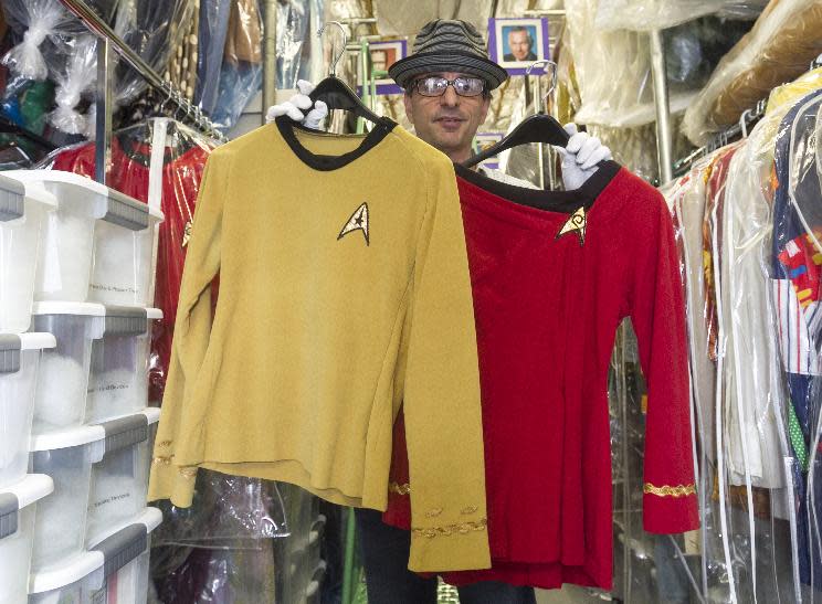 In this Friday, Nov. 30, 2012 photo, James Comisar shows costumes from the "Star Trek" original series. The items are part of his television memorabilia collection in a temperature- and humidity-controlled warehouse in Los Angeles. (AP Photo/Damian Dovarganes)