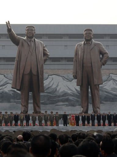 North Korean leader Kim Jong-Un (C) attends the unveiling ceremony of statues of former leaders Kim Il-Sung and Kim Jong-Il in Pyongyang