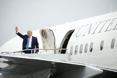 U.S. President Donald Trump waves while boarding Air Force One prior to departing Morristown Municipal Airport en route Camp David, Maryland, where he'll meet with his national security team to discuss a U.S. security strategy for South Asia that includes sending more U.S. soldiers to Afghanistan, in Morristown, New Jersey, U.S., August 18, 2017. REUTERS/Kevin Lamarque