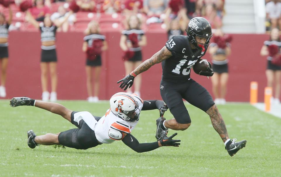 Iowa State Cyclones' wide receiver Jaylin Noel (13) breaks a tackle from Oklahoma State Cowboys' safety Cameron Epps (7) and runs for first down during the first quarter of an NCAA college football game at Jack Trice Stadium on Saturday, Sept. 23, 2023, in Ames, Iowa.