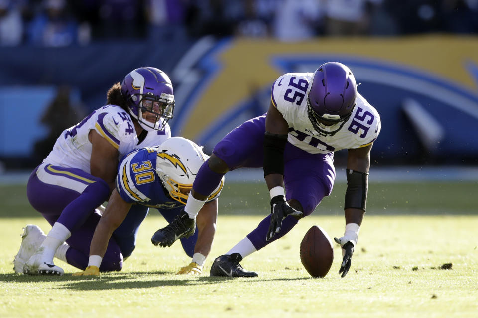 Minnesota Vikings defensive end Ifeadi Odenigbo, right, recovers a fumble before running it back for a touchdown during the first half of an NFL football game against the Los Angeles Chargers, Sunday, Dec. 15, 2019, in Carson, Calif. (AP Photo/Marcio Jose Sanchez)