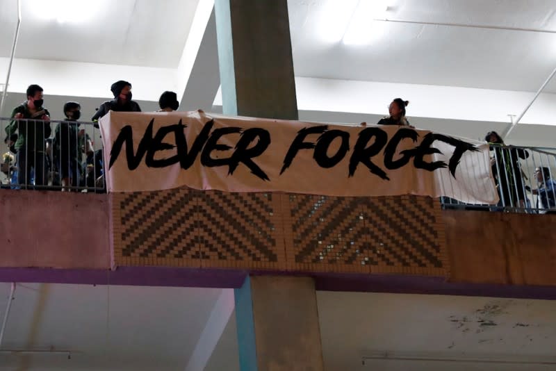 People gather to commemorate a student who died after he fell during a protest in Hong Kong