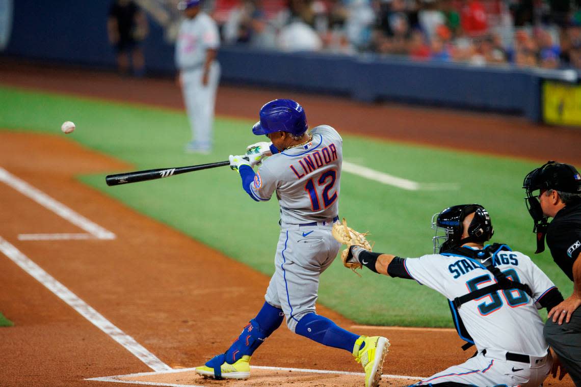 New York Mets shortstop Francisco Lindor (12) hits a double during the first inning of a baseball game against the Miami Marlins at LoanDepot Park on Sunday, July 31, 2022 in Miami, Florida.