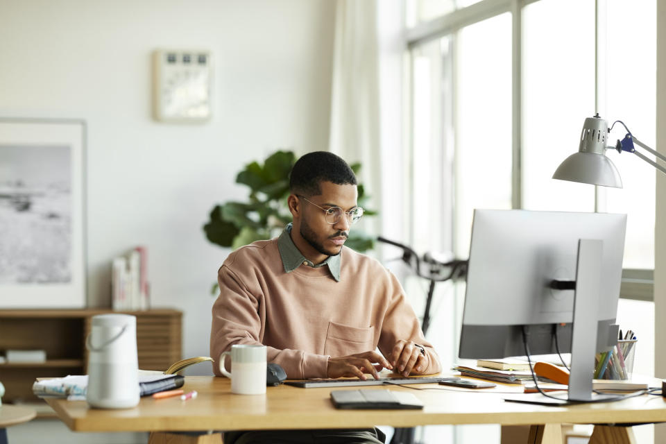 A man sitting at his desk and working.