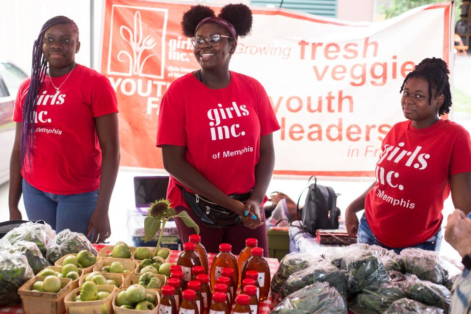 From left, Kendra Bowlex, Kendall Cooper and Alzalea Braxton, with Girls Inc., talk about their products during a tour of the Memphis Farmers Market on Saturday, June 22, 2019.