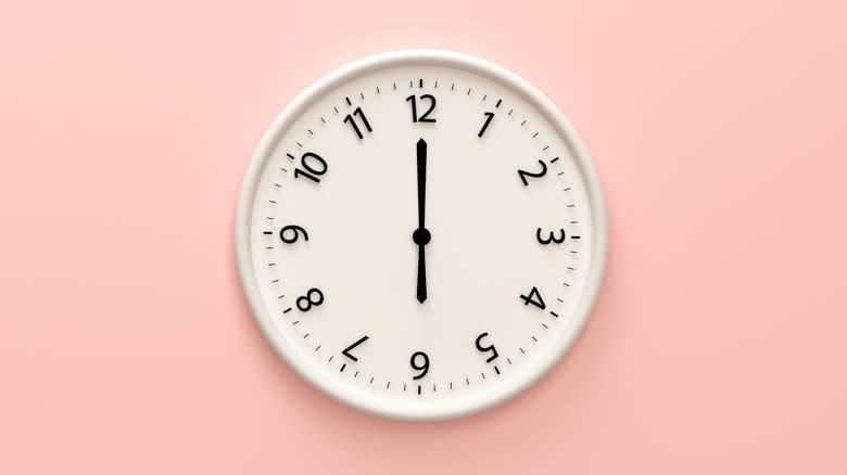 white clock on pink wall