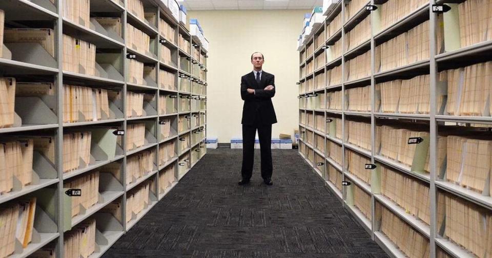 In this 2015 photo, Mecklenburg County Public Defender Kevin Tully stands among files in the public defender’s office.