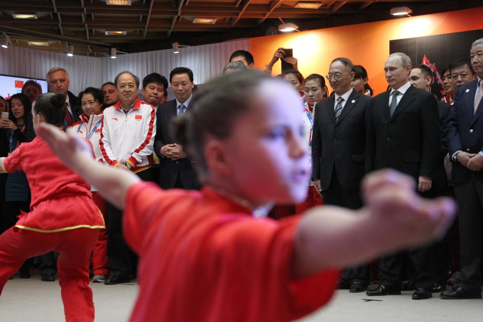 Russian President Vladimir Putin watches a Chinese martial arts competition as he visits the Chinese Delegation House at the 2014 Winters Olympics February 10, 2014 in Sochi, Russia.  