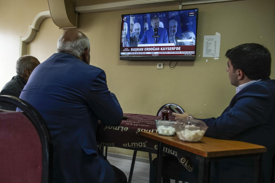 People watch Turkish President and People's Alliance's presidential candidate Recep Tayyip Erdogan shown in a tv screen, in a coffee house in Istanbul, Turkey, Saturday, May 6, 2023. (AP Photo/Emrah Gurel)