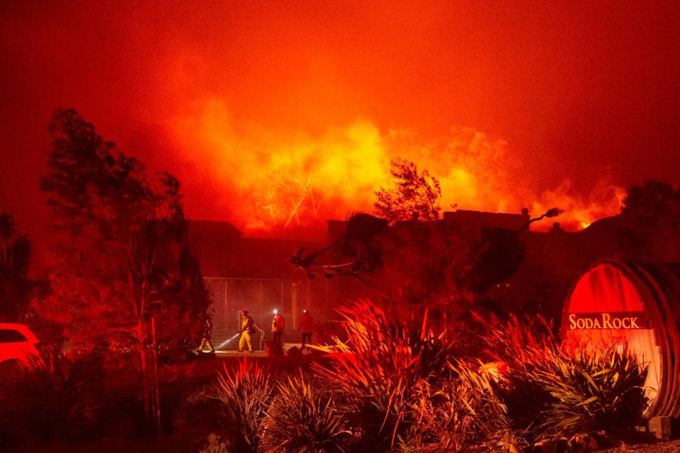 Firefighters have had to contend with powerful winds with at least one gust clocked at 102 miles per hour: AFP via Getty Images