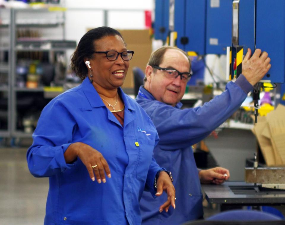 Euridice "Belinda" Medina of Brockton, an electro-mechanical assembler, and Bill Keiley, storeroom clerk, work together at one of the manufacturing stations on Wednesday, Sept. 7, 2022. Atrenne Vice President Jim Tierney says the teamwork concept is very important in ensuring the highest quality of Atrenne's products.