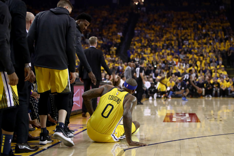 OAKLAND, CALIFORNIA - APRIL 15:  DeMarcus Cousins #0 of the Golden State Warriors falls to the crowd after injuring himself against the LA Clippers during Game Two of the first round of the 2019 NBA Western Conference Playoffs at ORACLE Arena on April 15, 2019 in Oakland, California.  NOTE TO USER: User expressly acknowledges and agrees that, by downloading and or using this photograph, User is consenting to the terms and conditions of the Getty Images License Agreement.  (Photo by Ezra Shaw/Getty Images)