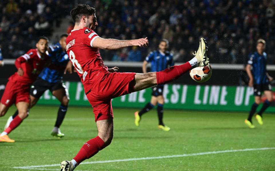 Liverpool midfielder Dominik Szoboszlai reaches for the ball