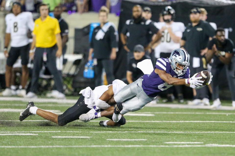 Sep 23, 2023; Manhattan, Kansas, USA; Kansas State Wildcats wide receiver Phillip Brooks (8) is tackled short of a first down by UCF Knights defensive back Demari Henderson (8) during the fourth quarter at Bill Snyder Family Football Stadium. Mandatory Credit: Scott Sewell-USA TODAY Sports