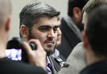 Mohamed Alloush of the Jaysh al Islam and member of the High Negotiations Committee (HNC) talks to reporters after the Geneva peace talks were paused in Geneva, Switzerland, February 3 , 2016. REUTERS/Pierre Albouy