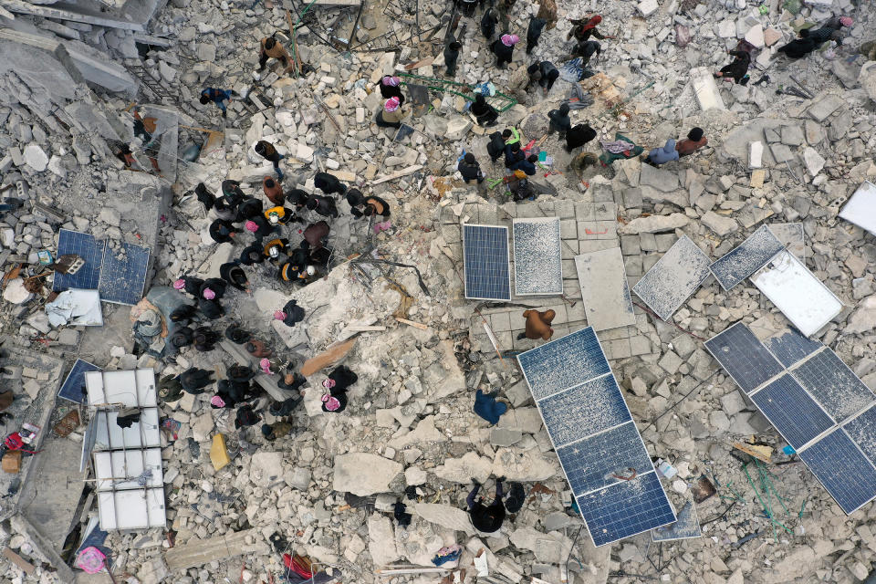 Civil defense workers and residents search through the rubble of collapsed buildings in the town of Harem near the Turkish border, Idlib province, Syria.<span class="copyright">Ghaith Alsayed—AP</span>