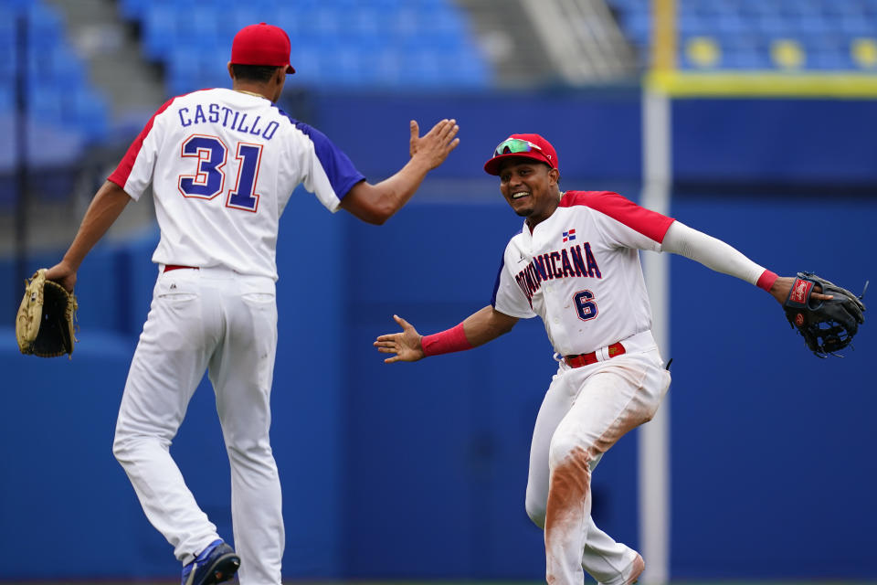 Dominican Republic's Erick Mejia, right, and Luis Castillo celebrate after Dominican Republic won a baseball against against Mexico at Yokohama Baseball Stadium during the 2020 Summer Olympics, Friday, July 30, 2021, in Yokohama, Japan. (AP Photo/Matt Slocum)