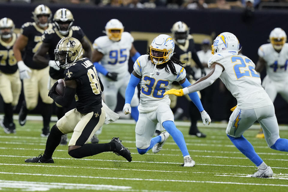 New Orleans Saints wide receiver Jarvis Landry (80) runs from Los Angeles Chargers cornerback Ja'Sir Taylor (36) and safety JT Woods (22) after catching a pass during the first half of a preseason NFL football game in New Orleans, Friday, Aug. 26, 2022. (AP Photo/Gerald Herbert)