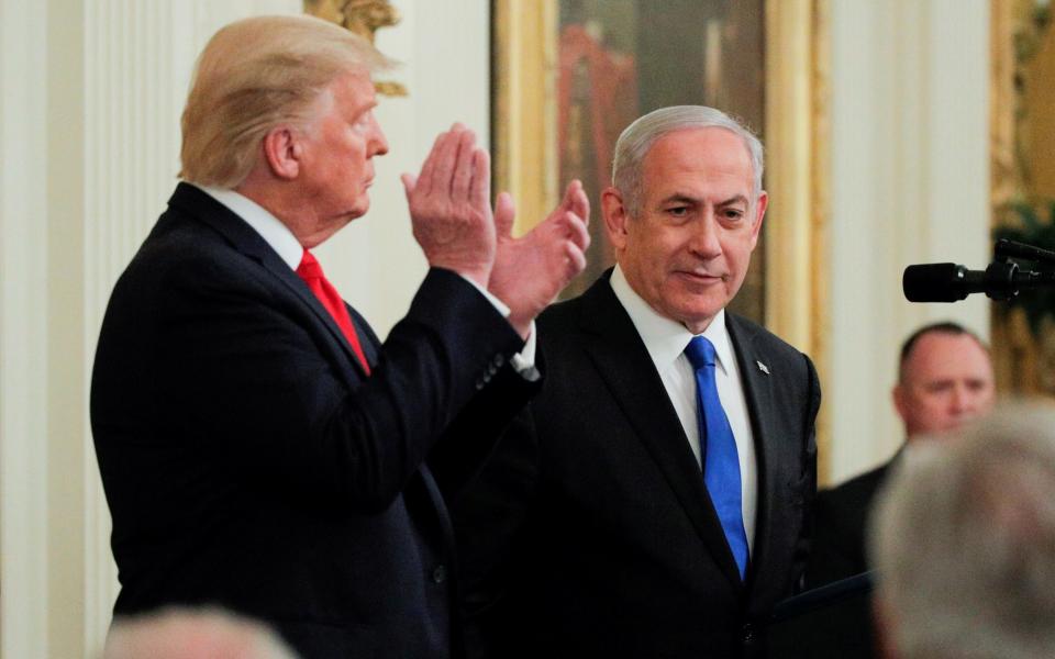 President Donald Trump applauds Israel's Prime Minister Benjamin Netanyahu at a press conference in Washington - Reuters