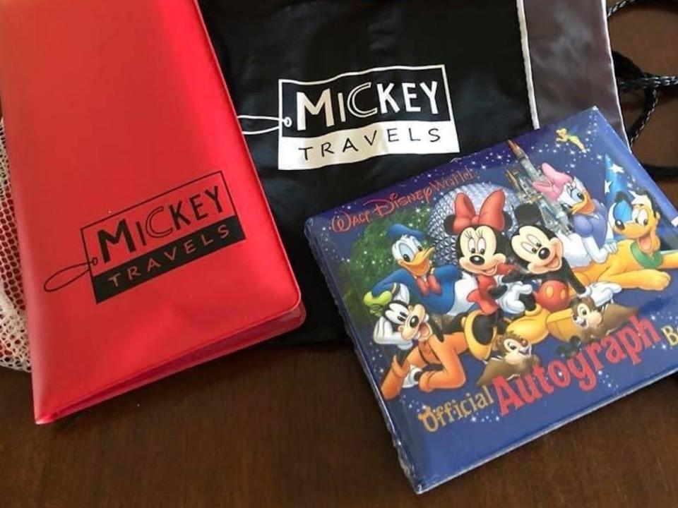 A bag of Disney souvenirs, including an autograph books.