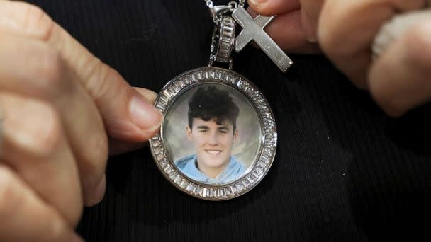 PHOTO: Gena Hoyer shows the pendant given to her by coworkers bearing an image of her son, Luke Hoyer, 15, who was killed in the 2018 Marjory Stoneman Douglas High School shootings in Fort Lauderdale, Fla., Oct. 20, 2021. (Amy Beth Bennett/AP, FILE)